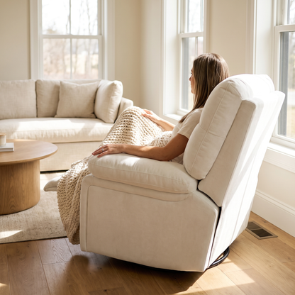 Woman relaxing, in The Solace Power Swivel Rocker Recliner, Heat + Massage in a sunny living room