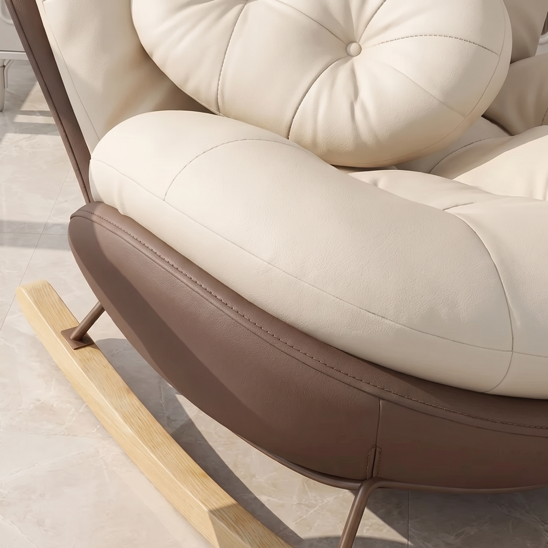 Close-up of The Nook: cream cushion, curved shell and wood rocker