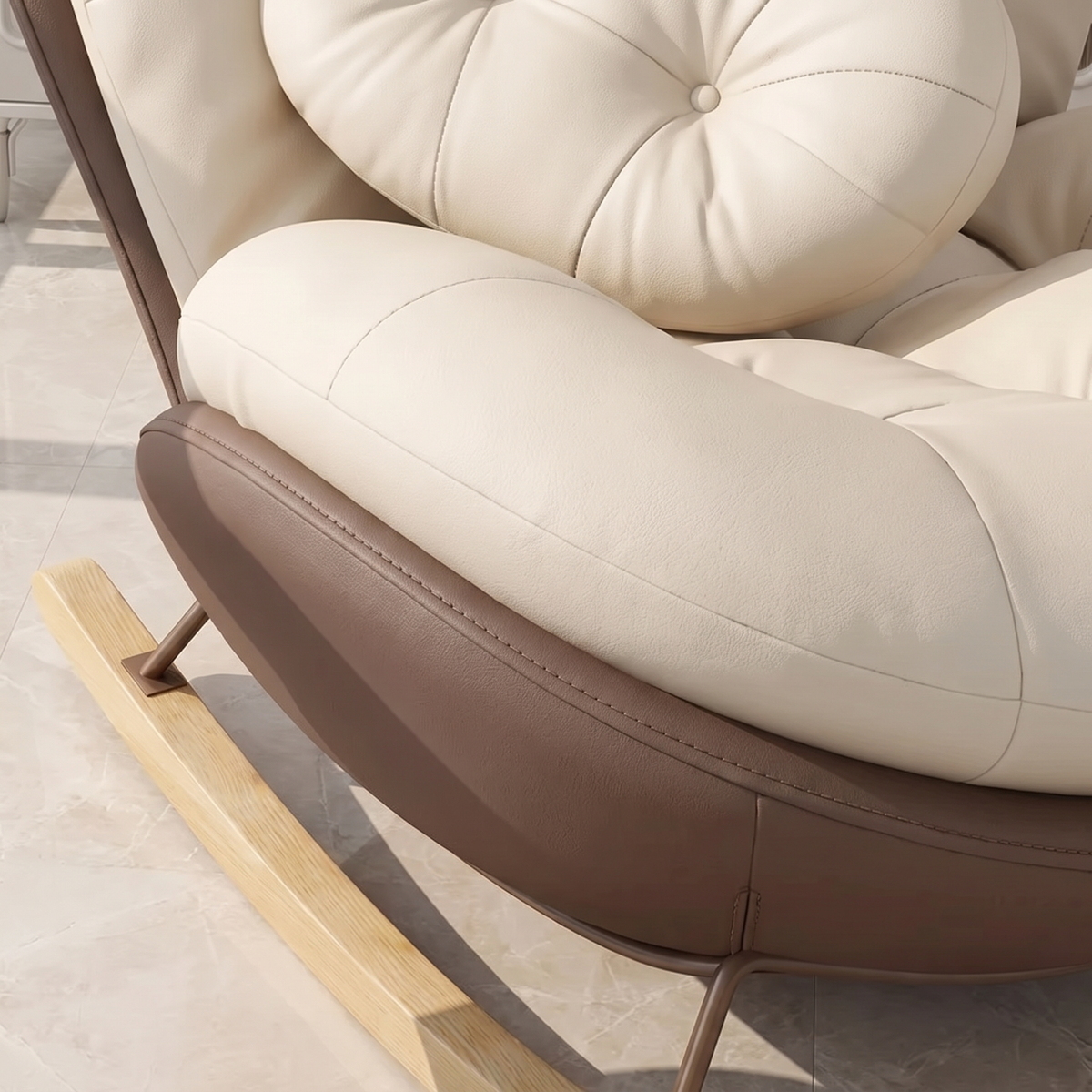 Close-up of The Nook: cream cushion, curved shell and wood rocker