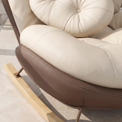 Close-up of The Nook: cream cushion, curved shell and wood rocker