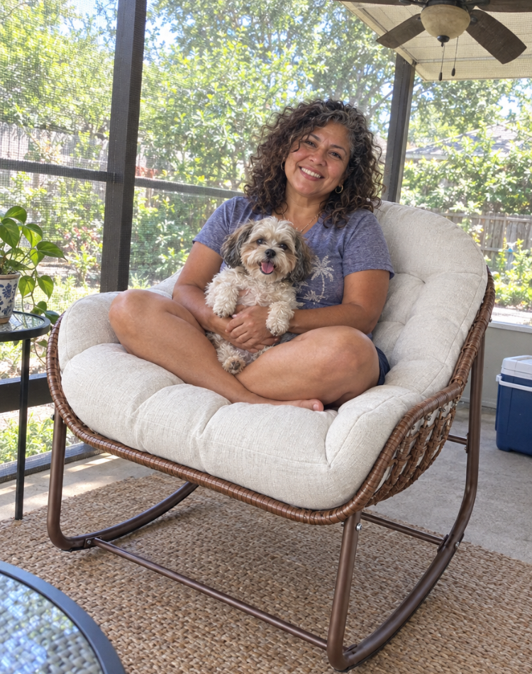 Woman holding her dog on a cushioned wicker rocking chair on a screened porch