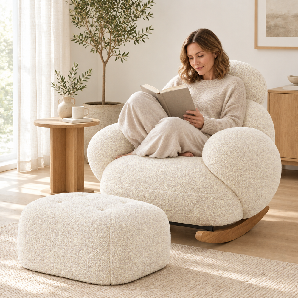 Woman reading a book in The Mochi boucle cloud rocker with its ottoman in a bright living room