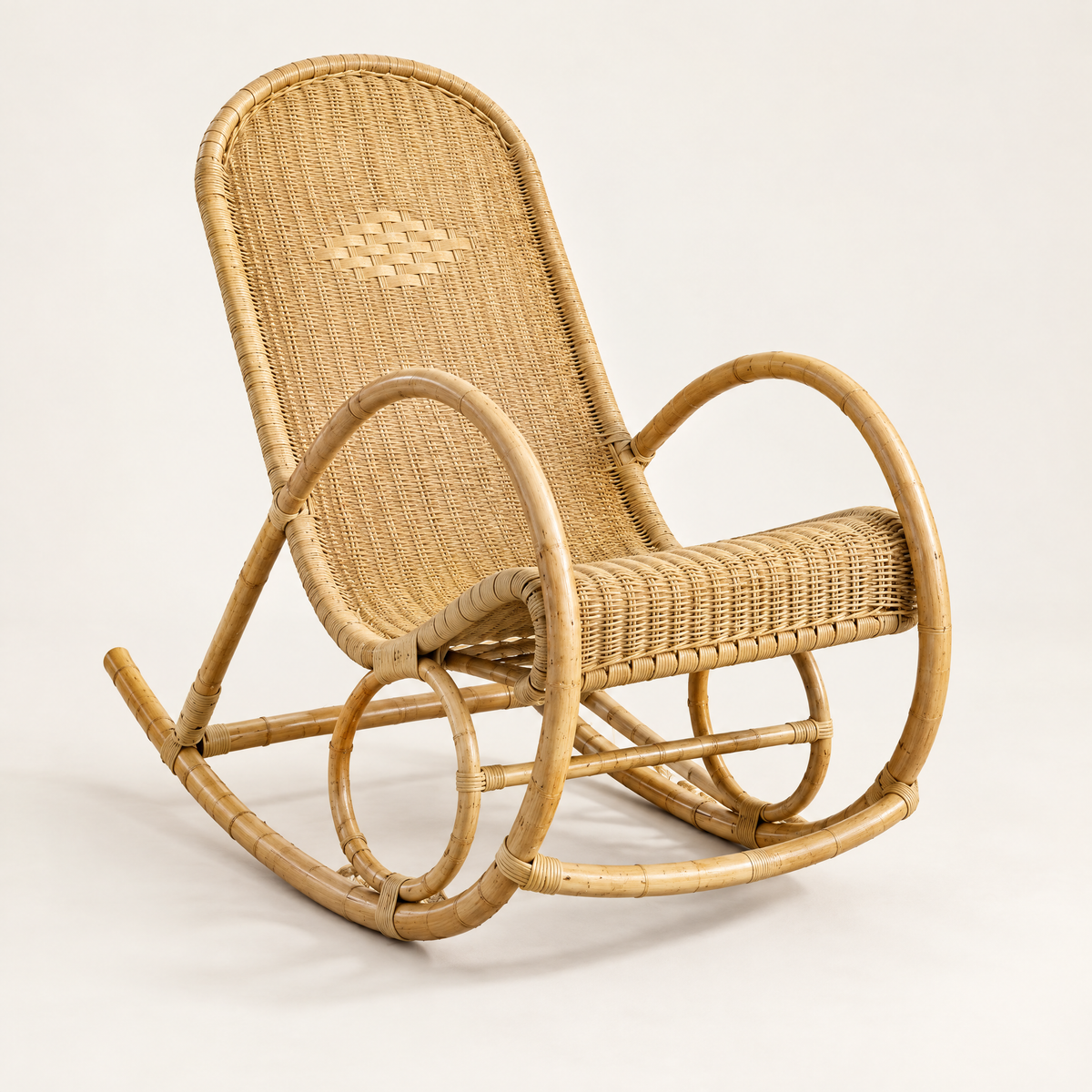 The Weaver hand-woven rattan rocker in Natural, studio photo